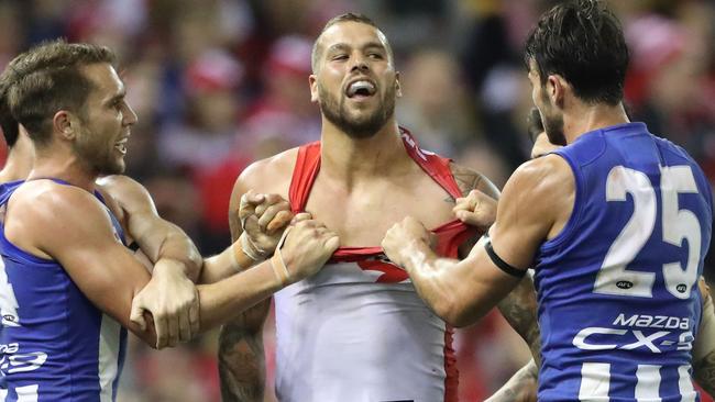 Lance Franklin takes on two Kangaroos.