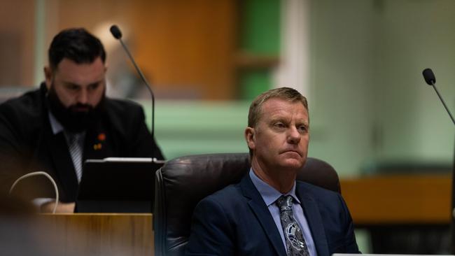 Deputy Speaker Mark Turner, left, and Minister for Small Business Paul Kirby listen as Chief Minister Michael Gunner delivers the 2020-2021 Northern Territory Budget. Picture: Che Chorley