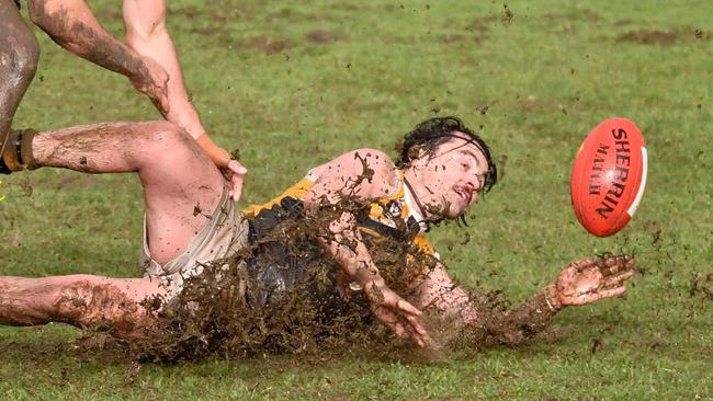 Frankston YCW's Ben Wagner slides with Frankston Bombers player Jason Kingsbury in pursuit. Picture: Rab Siddhi