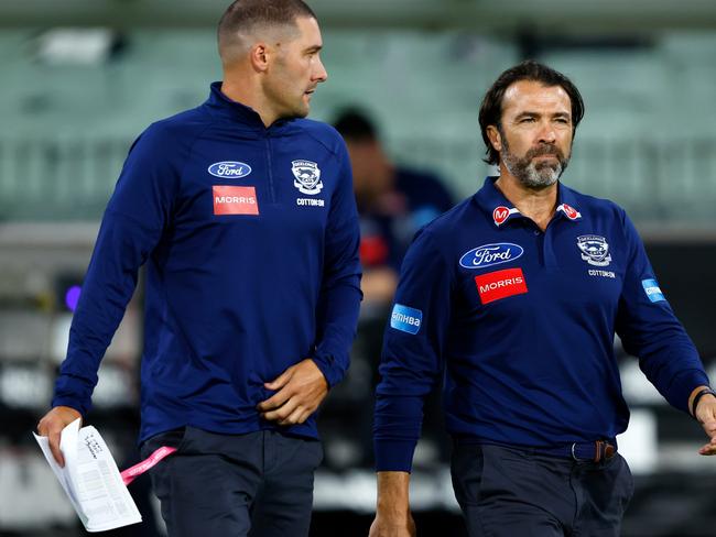 Chris Scott steps out with Shaun Grigg. Picture: Dylan Burns/AFL Photos via Getty Images)