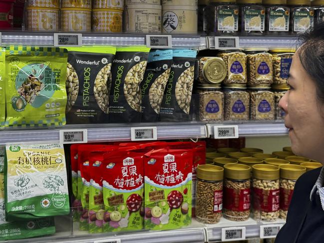 A woman looks at nuts imported from the United States, on display for sale with others at the Hema supermarket in Beijing, Sunday, May 11, 2025. Picture: AP Photo/Andy Wong