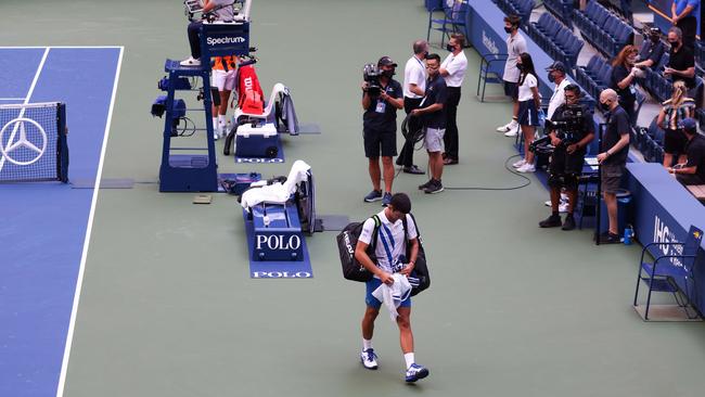 Novak Djokovic walks off the court after being defaulted due to inadvertently striking a lineswoman with a ball. Picture: Getty Images