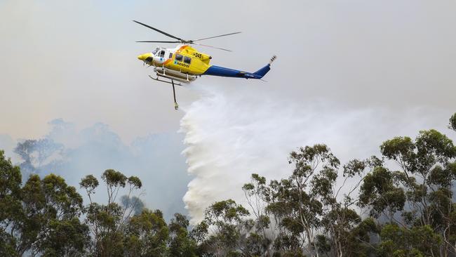 A helicopter drops water over a fire in Plenty Gorge Parklands as homes in Nillumbik came under threat. Picture: Ian Currie