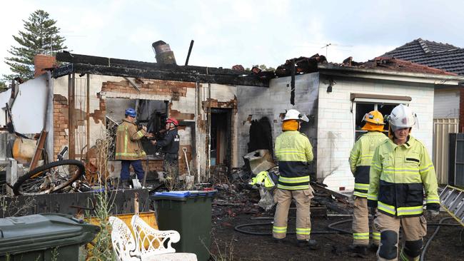 Fire investigators at the Yorkshire Street property. Picture: Dean Martin/AAP