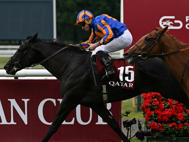 RL Moore riding Camille Pissaro crosses the finish to win the 185th Qatar Prix du Jockey Club horse race at the Chantilly race course, north of Paris on June 1, 2025. (Photo by Hugo MATHY / AFP)