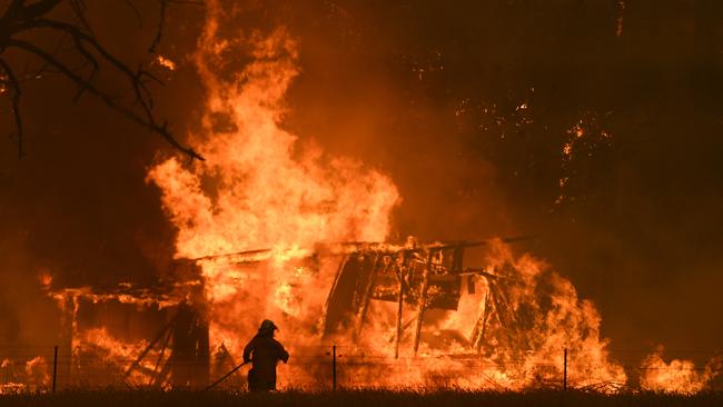 NSW Rural Fire Service crews fight the Gospers Mountain Fire as it impacts a structure at Bilpin on Saturday. Picture: AAP/Dan Himbrechts