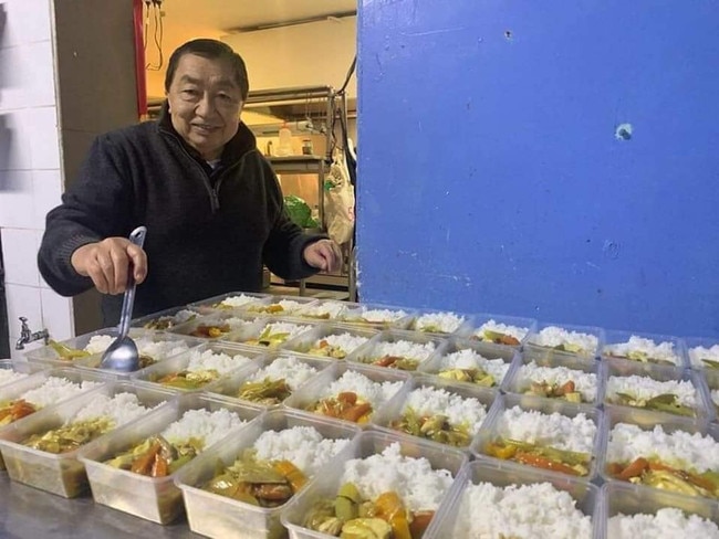 Harry Hunt pictured, dishing out rice with curry in identical rows.