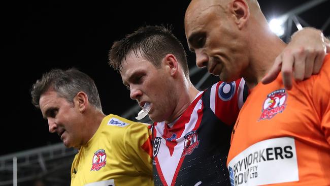 SYDNEY, AUSTRALIA - MARCH 26:  Luke Keary of the Roosters is helped off the field after a leg injury during the round three NRL match between the South Sydney Rabbitohs and the Sydney Roosters at Stadium Australia on March 26, 2021, in Sydney, Australia. (Photo by Cameron Spencer/Getty Images)