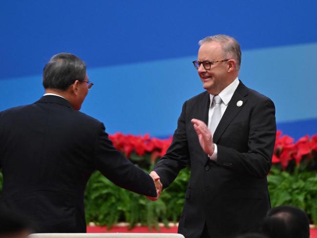 China's Premier Li Qiang (L) and Australia's Prime Minister Anthony Albanese shake hands during the opening ceremony of the 6th China International Import Expo (CIIE) in Shanghai on November 5, 2023. (Photo by Hector RETAMAL / AFP)