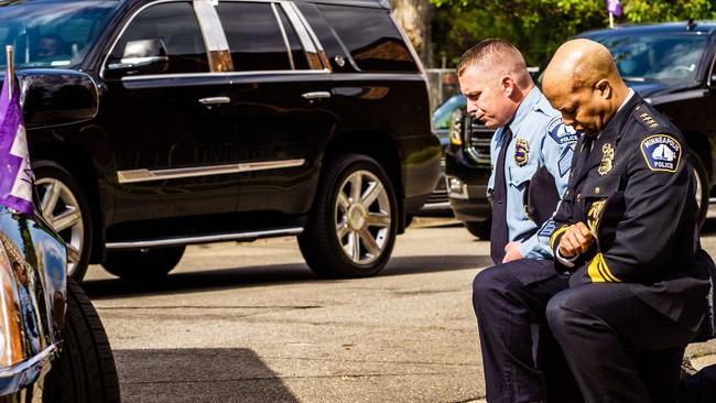 Minneapolis Police Chief Medaria Arradondo, right, kneels as the remains of George Floyd are taken to a memorial service in his honour on June 4, 2020 Picture: Kerem Yucel/AFP