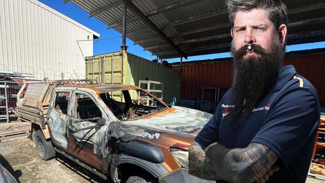 Shane Coleman in front of his car that was stolen