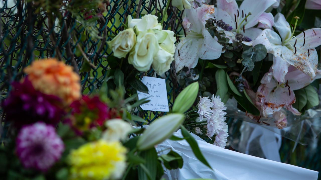 Flowers adorn the fence near the site of the deadly attack. Picture: Julian Andrews