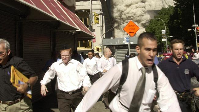 People run from the collapse of one of the twin towers. Picture: Suzanne Plunkett