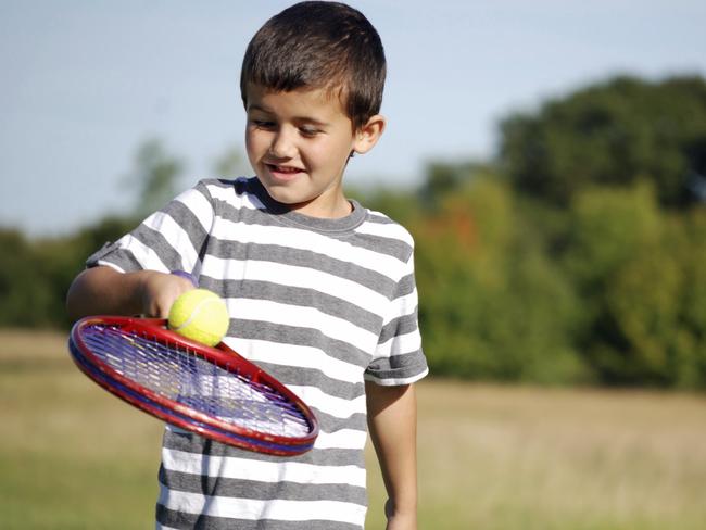 Active child playing tennis