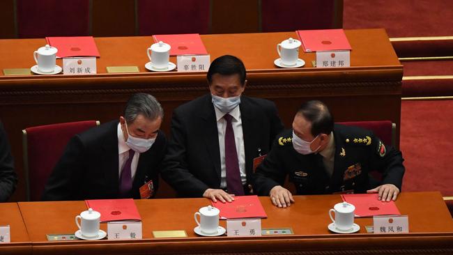 Wang Yi, left, and Wei Fenghe, right, converse during the closing session of the National People’s Congress in Beijing on Friday. Picture: AFP