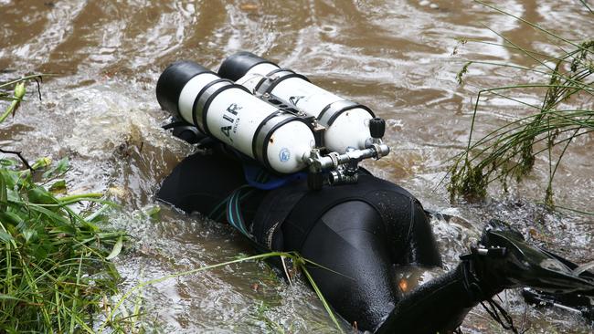 One of the diver scours the waterway. Picture: NCA NewsWire / Peter Lorimer.