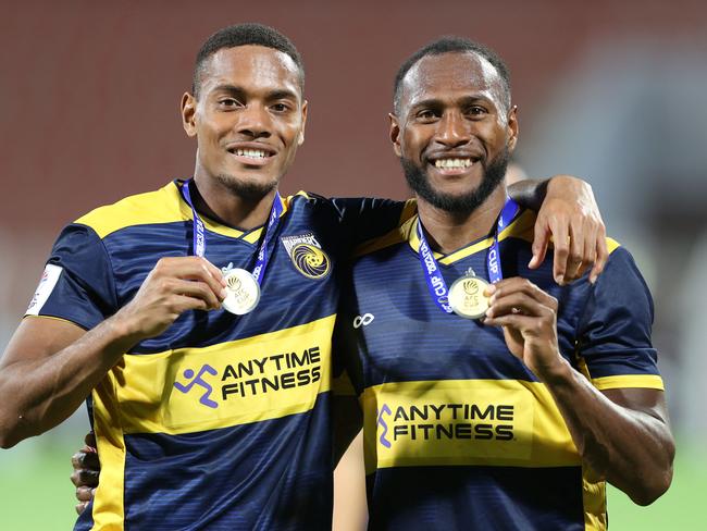 Central Coast Mariners' Fijian defender Dan Hall (L) and Ni-Vanuatu defender Brian Kaltak pose with their medals after winning the AFC Cup final football match between Lebanon's Al-Ahed and Australia's Central Coast Mariners at the Sultan Qaboos Sports Complex in Muscat on May 5, 2024. (Photo by Haitham AL-SHUKAIRI / AFP)