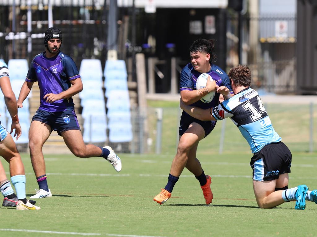 Stanley Huen is tackled by Luke Raymond in the SG Ball Cup. Picture: Steve Montgomery/Ourfootyteam.com