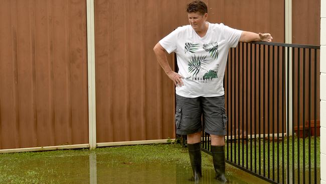 Leanne Dobbin, standing in seage in her backyard, is one of many Wulguru residents that experiences poonami when the rain comes. Picture: Evan Morgan