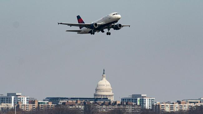 A plane takes off from Reagan National Airport after the crash of an American Airlines plane on Potomac River as it approached the airport on January 30. Picture: Al Drago/Getty Images/AFP