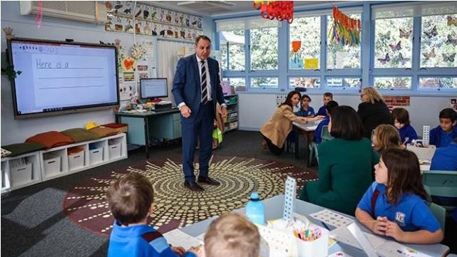 Secretary of the NSW Education Department, Murat Dizdar, with students at Toongabbie East Public School, said h wansted head office staff to “go back to school”. Picture: NSW Department of Education