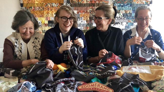 Volunteers make reusable bags for DoSomething Day