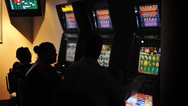 Anonymous person gambling by using a pokie machine at The Grand Hotel, Goondoon St Gladstone. Picture: CHRISSY HARRIS  poki180210-