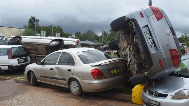 Cars that were left in the South Lismore Bowls Club carpark were flipped on top of each other Picture: Nicholas Rupolo.