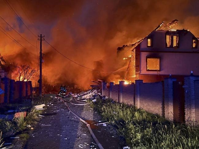 In this photo provided by the Ukrainian Emergency Service, firefighters try to put out a fire following a Russian attack in Kyiv region, Ukraine on May 25. Picture: Ukrainian Emergency Service via AP