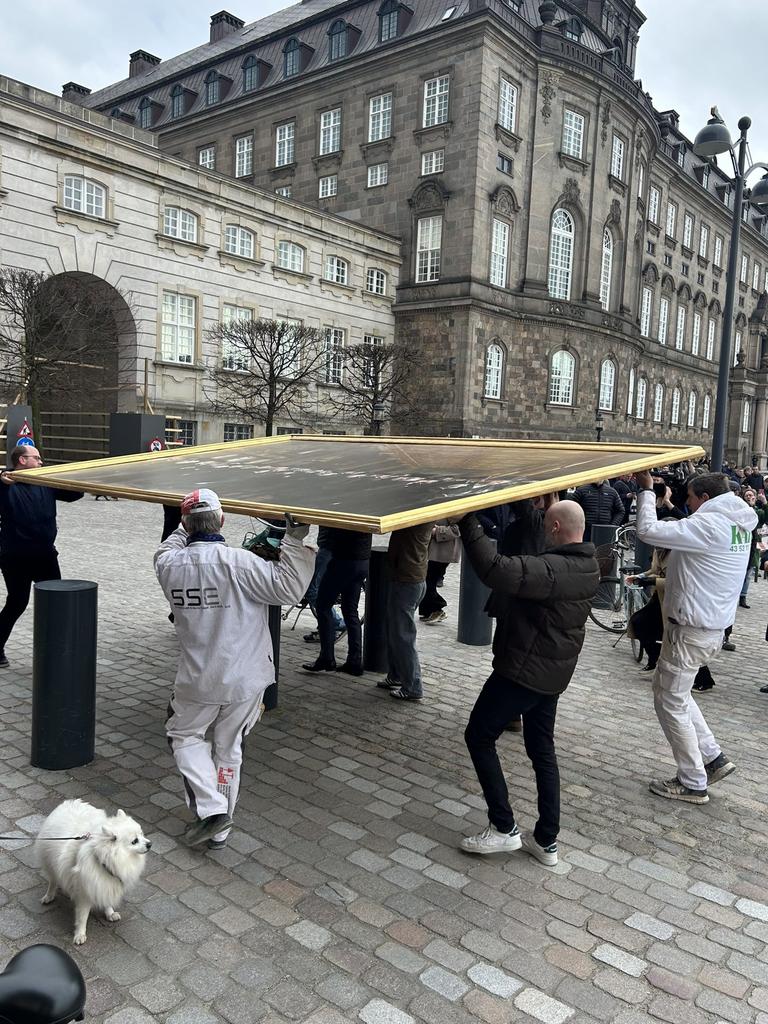 Firefighters, soldiers and locals all helped carry the artwork out of harm's ways. Picture: X/Mads Bisgaard via Storyful