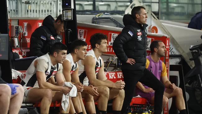 Nick Daicos (second from left) is seen on the interchange bench as he was hobbled by an ankle injury in the shock defeat. (Photo by Daniel Pockett/Getty Images)