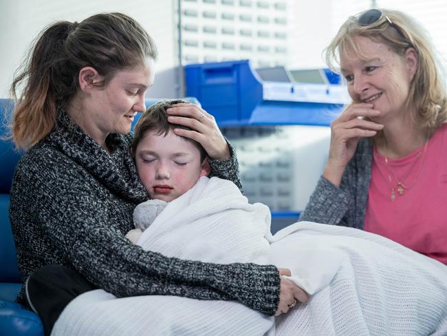 Jayden Ryan, 7, with mother Kylie Zahra and grandmother Fawna Lennon post op. Picture: Jake Nowakowski