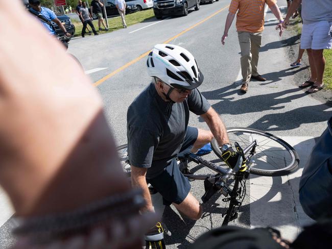 The US President had trouble releasing his bike shoes from the toe cages on the pedals. Picture: AFP