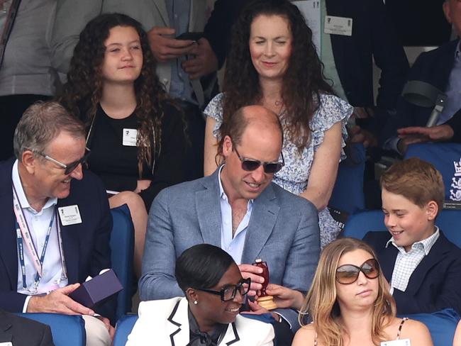 Prince George shows his father the replica Ashes Urn. Picture: Getty Images