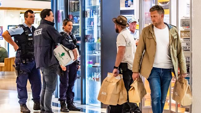 Police officers remove bags of evidence after the raid at Cignall. (AAP IMAGE/MONIQUE HARMER)