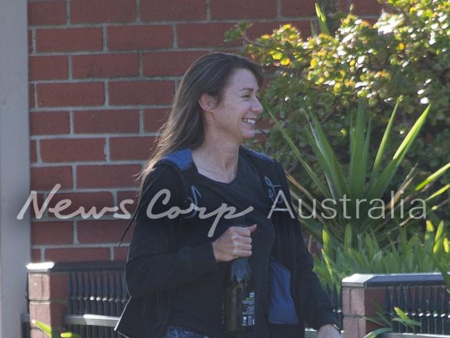 A joyful Yvette Nikolic was seem laughing as she carried a bottle of wine into a Port Melbourne. Picture: Matrix for News Corp Australia