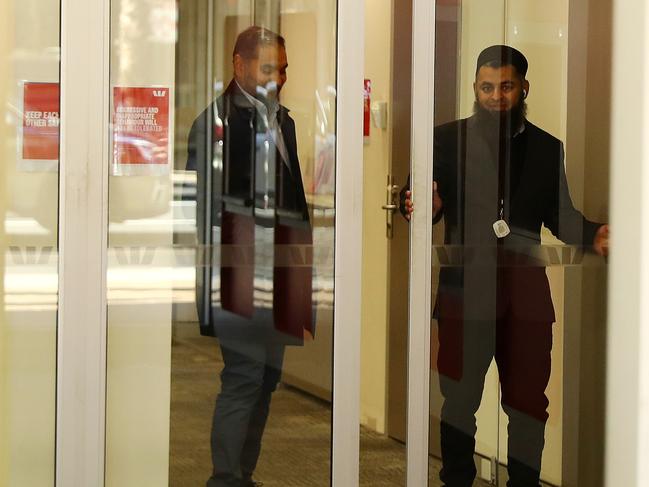 A security guard on the front door of Westpac Geelong letting in customers one at a time. Picture: Alison Wynd