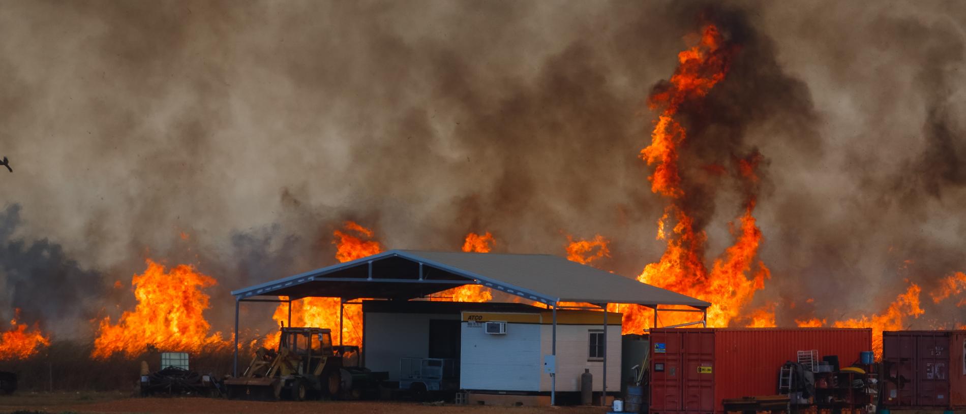 A fire front threatens farm infrastructure as dangerous fire conditions continued through the Litchfield/Batchelor area in late August. Picture: Glenn Campbell