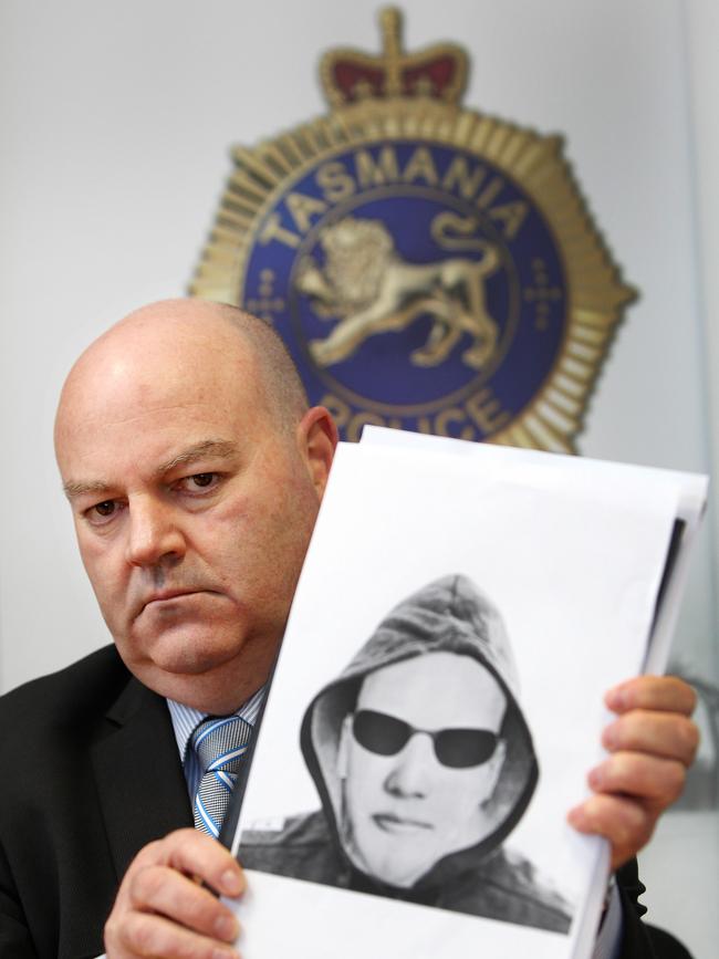 Detective Inspector Rob Gunton holds an identikit image at the Devonport Police Station after the 12-year-old girl was abducted in 2014.