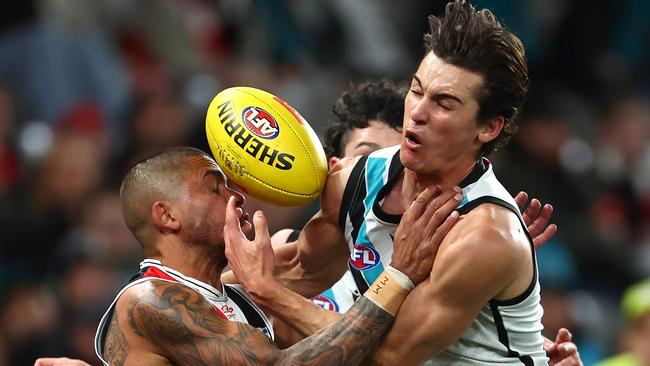 Connor Rozee flies for a mark against Bradley Hill. Picture: Quinn Rooney/Getty Images