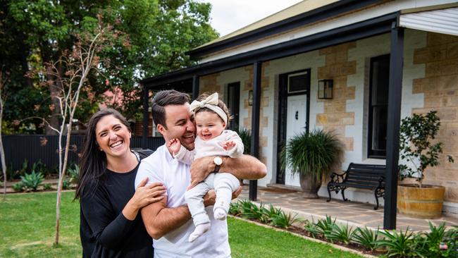 Alex and Rachel with baby Eva in front of the Hawthorn home they recently bought at auction. Picture: Tom Huntley