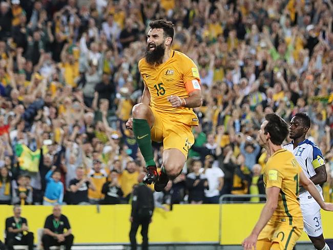 The sky-high skipper! Mile Jedinak celebrates his second penalty.