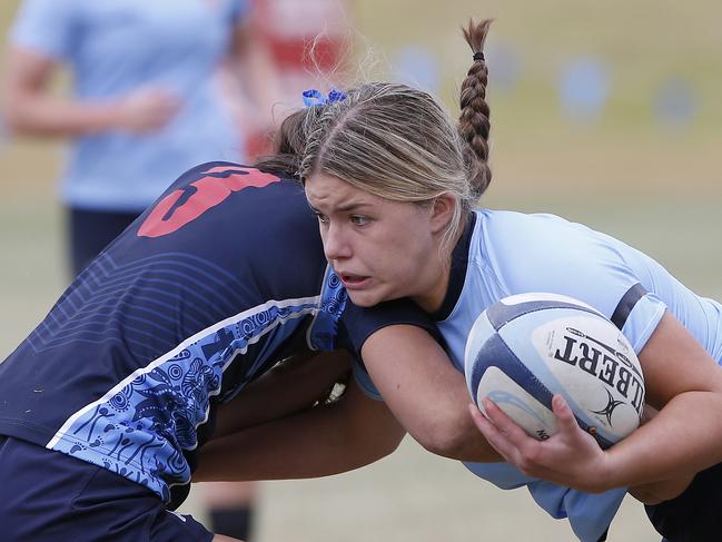 CHS1's Lacey Cross with the ball. Girls Rugby Sevens Grand Final. CHS1 (light blue) v CCC1 (dark blue). Action from game. Junior Rugby. NSW Schools Rugby union trials at Eric Tweedale Oval. Picture: John Appleyard