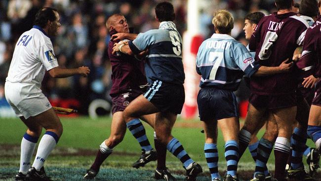 A touch judge (L) tries to stop Jamie Goddard and Andrew Johns (9) from fighting in Game 3 of 1997 Origin series. Photo: Gregg Porteous.