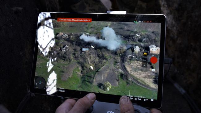 Smoke clouds rising above a struck target are seen on a monitor as a Ukrainian serviceman of the Adam tactical group operates a drone to spot Russian positions near the city of Bakhmut, Donetsk region. Picture: AFP
