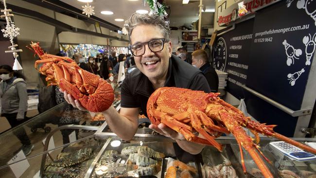 George Milonas, with ‘the Cray Twins’, is flying in more lobsters for his store at Melbourne’s Queen Victoria Market after he sold out on Wednesday. Picture: David Geraghty