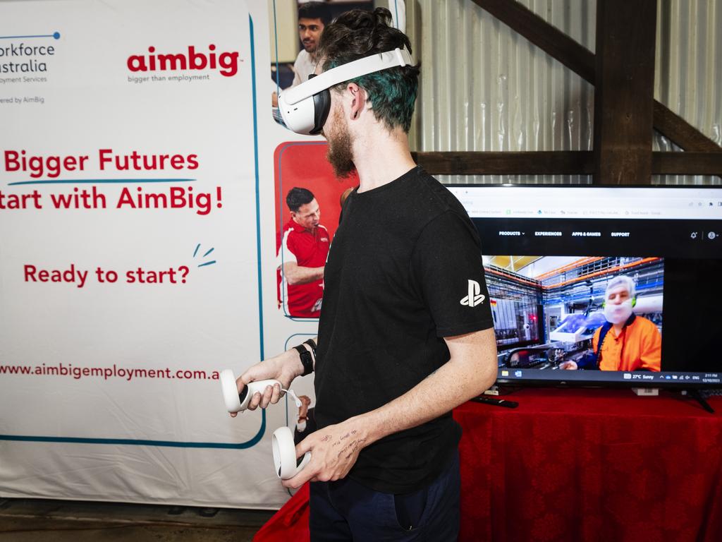 Lachlan Reid using a VR workplace simulation at the AimBig stall. Picture: Kevin Farmer