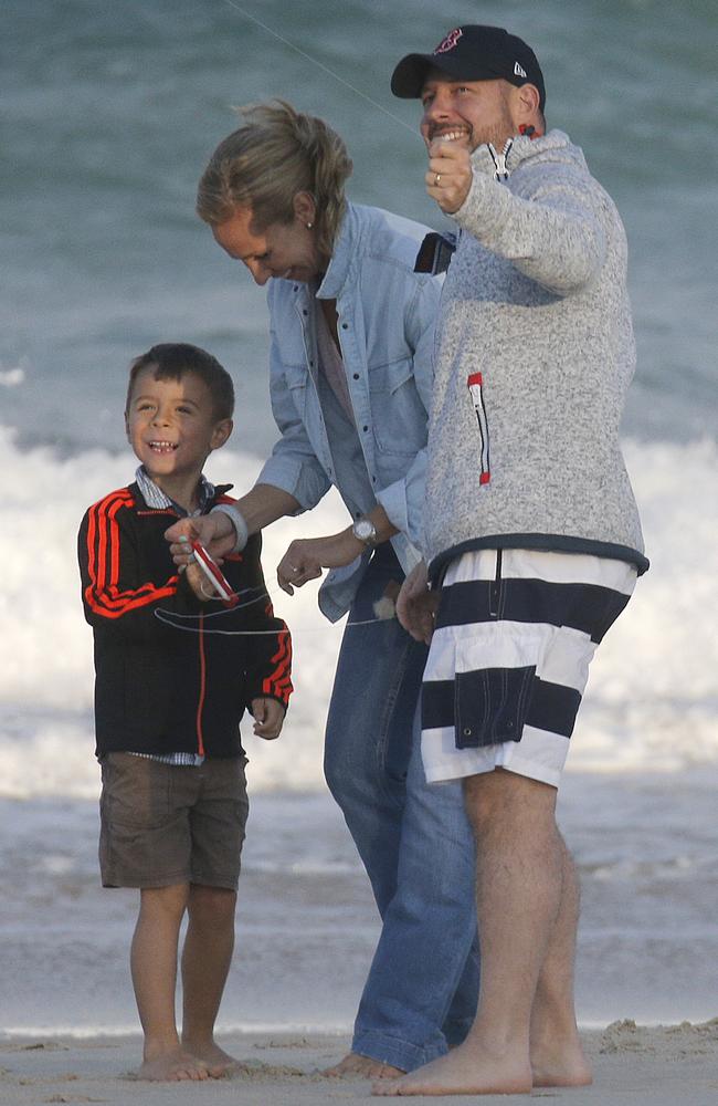 Adam Wittington with his wife Karin and  son on the beach in Brisbane where they were filming for Sunday Night. Picture: Nathan Richter/INFphoto