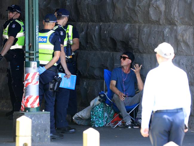 The homeless man is approached by police after abusing passers by. Picture: Alex Coppel.