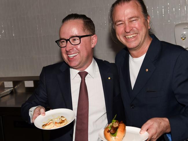 Qantas chief executive Alan Joyce and chef Neil Perry serve food during the opening of the new transit lounge at Perth Airport prior to the inaugural Qantas 787 Dreamliner flight from Perth to London. Picture: AFP